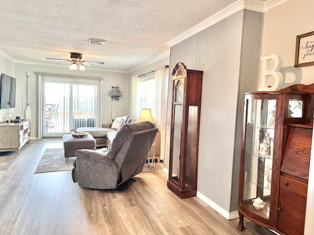 25419 County Road 327, Urbana, MO 65767 - living area featuring light wood finished floors, ceiling fan, a textured ceiling, and crown molding