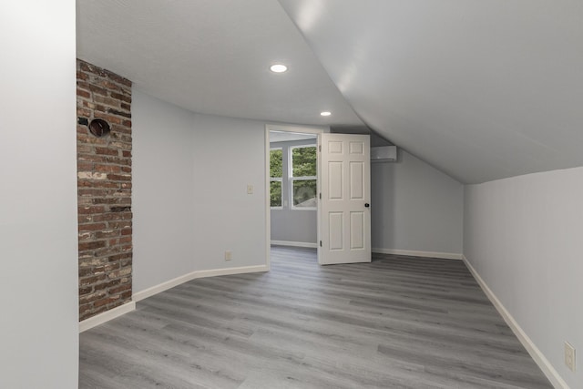 720 W Mount Vernon St, Springfield, MO 65806 - bonus room with wood finished floors, vaulted ceiling, recessed lighting, and a wall unit AC
