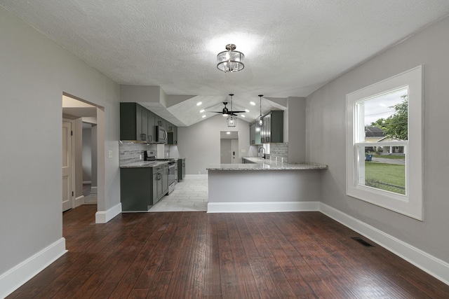 720 W Mount Vernon St, Springfield, MO 65806 - kitchen with appliances with stainless steel finishes, tasteful backsplash, a ceiling fan, hardwood / wood-style floors, and gray cabinetry