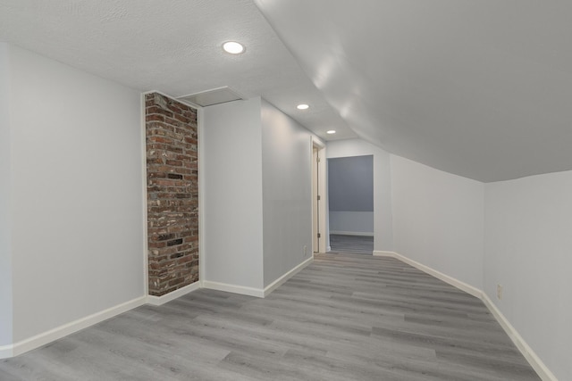 720 W Mount Vernon St, Springfield, MO 65806 - additional living space with wood finished floors, recessed lighting, vaulted ceiling, and a textured ceiling
