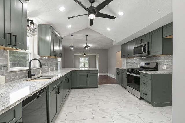 720 W Mount Vernon St, Springfield, MO 65806 - kitchen featuring stainless steel appliances, ceiling fan, a peninsula, light marble finish floors, and lofted ceiling