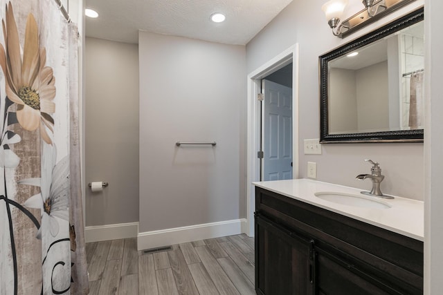 720 W Mount Vernon St, Springfield, MO 65806 - bathroom featuring vanity, wood finished floors, a shower with shower curtain, and recessed lighting