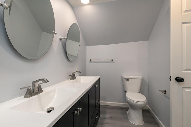 720 W Mount Vernon St, Springfield, MO 65806 - bathroom with vaulted ceiling, double vanity, and wood finished floors