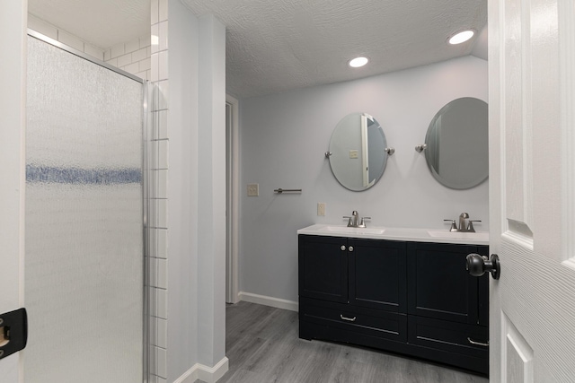 720 W Mount Vernon St, Springfield, MO 65806 - bathroom featuring a shower stall, wood finished floors, double vanity, and recessed lighting