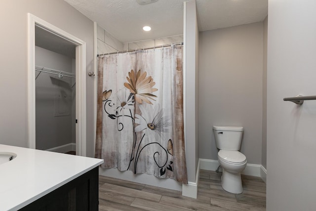 720 W Mount Vernon St, Springfield, MO 65806 - full bathroom with vanity, wood finished floors, a shower with curtain, a walk in closet, and recessed lighting