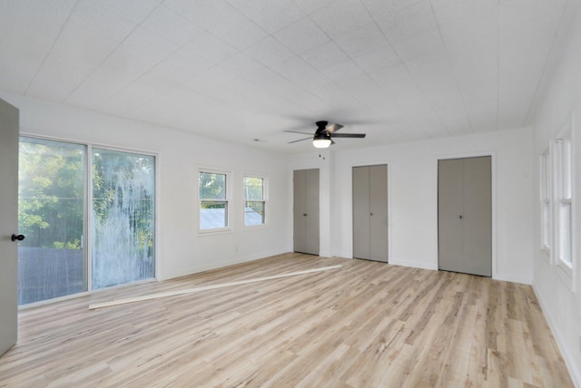 1169 S Miller Ave, Springfield, MO 65802 - unfurnished bedroom with two closets, access to outside, light wood finished floors, and ceiling fan
