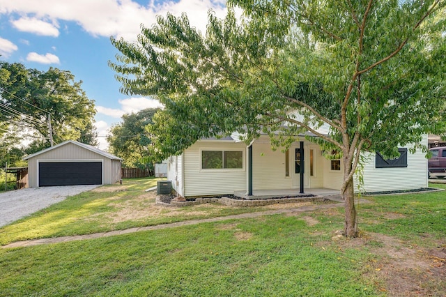 1169 S Miller Ave, Springfield, MO 65802 - view of front of house featuring a front yard, an outbuilding, a detached garage, and covered porch