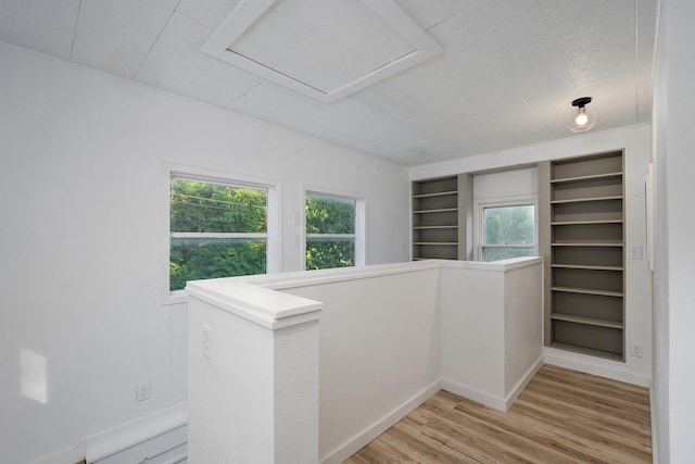 1169 S Miller Ave, Springfield, MO 65802 - hall featuring light wood-style flooring, an upstairs landing, built in shelves, and attic access