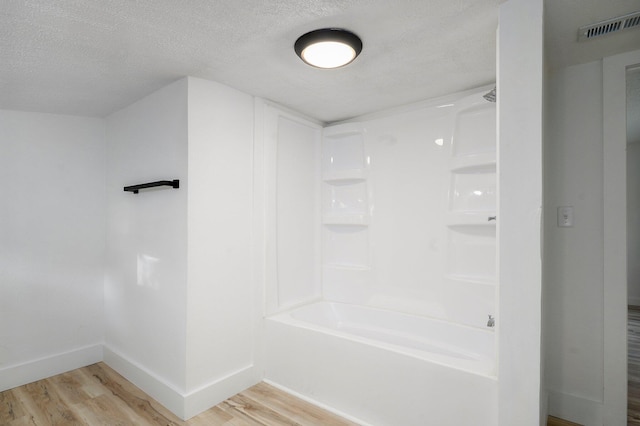 1169 S Miller Ave, Springfield, MO 65802 - full bath with wood finished floors, a textured ceiling, and  shower combination