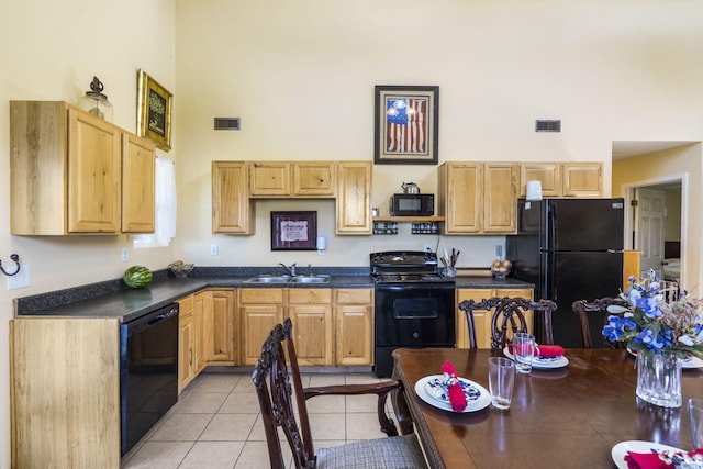 531 Plateau Dr, Marshfield, MO 65706 - kitchen with black appliances, a towering ceiling, dark countertops, light brown cabinetry, and light tile patterned floors