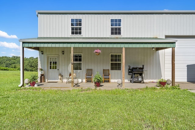 531 Plateau Dr, Marshfield, MO 65706 - back of house featuring a lawn, board and batten siding, a metal roof, and covered porch