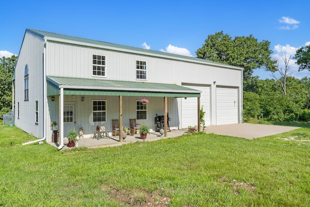 531 Plateau Dr, Marshfield, MO 65706 - back of house with a garage, a lawn, a metal roof, and a patio