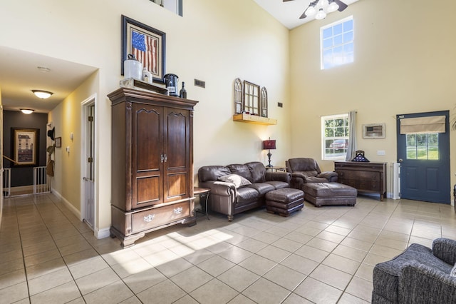 531 Plateau Dr, Marshfield, MO 65706 - living room with a towering ceiling, light tile patterned floors, a ceiling fan, and healthy amount of natural light
