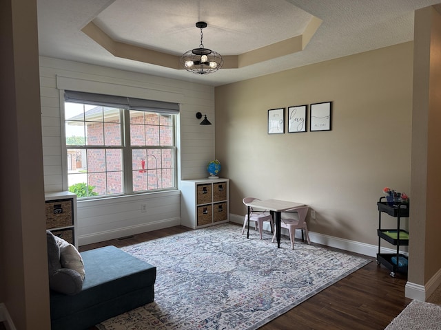 1129 S Erika Ave, Springfield, MO 65802 - living area with wood finished floors, a raised ceiling, and a textured ceiling