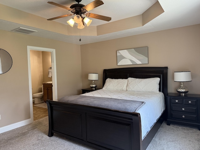 1129 S Erika Ave, Springfield, MO 65802 - bedroom featuring light colored carpet, ensuite bath, a ceiling fan, and a tray ceiling