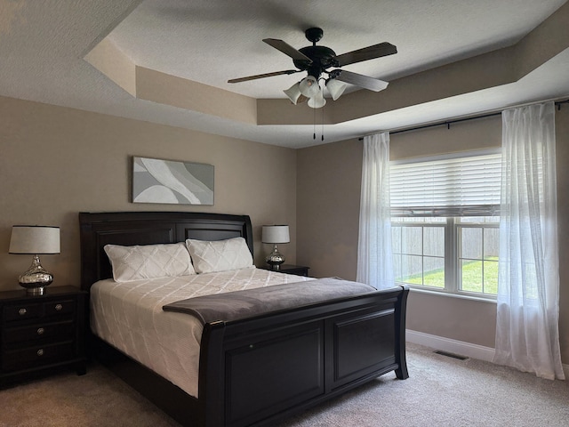 1129 S Erika Ave, Springfield, MO 65802 - bedroom featuring light colored carpet, a raised ceiling, ceiling fan, and a textured ceiling