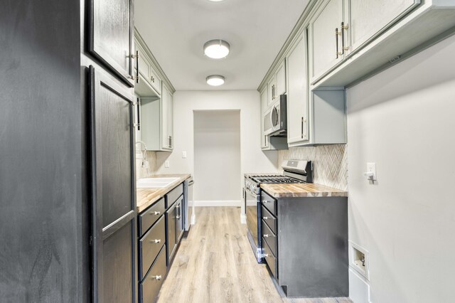 210 N Cedarbrook Ave, Springfield, MO 65802 - kitchen featuring appliances with stainless steel finishes, light wood finished floors, backsplash, and butcher block counters
