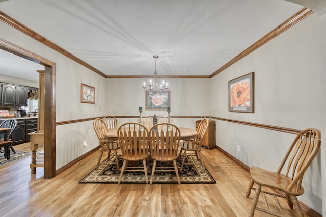 1820 E Jacqueline St, Springfield, MO 65804 - dining room featuring light wood-type flooring, a chandelier, and ornamental molding