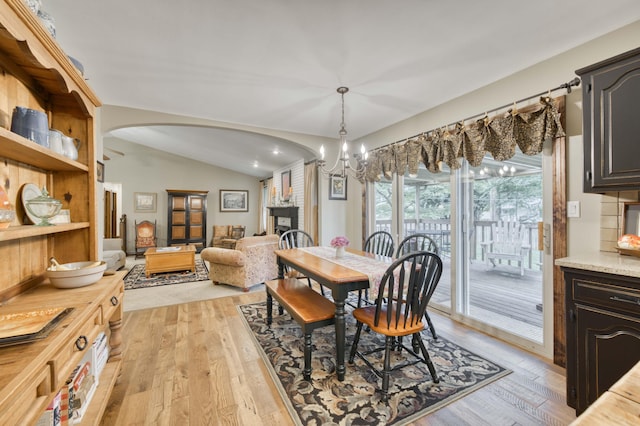 1820 E Jacqueline St, Springfield, MO 65804 - dining room featuring arched walkways, light wood-style floors, vaulted ceiling, a chandelier, and recessed lighting