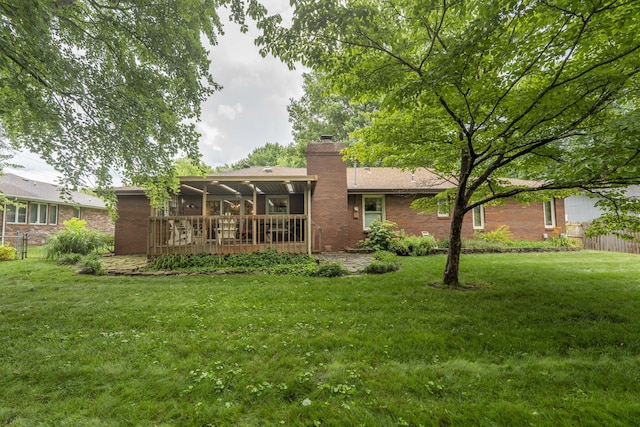 1820 E Jacqueline St, Springfield, MO 65804 - back of house with a chimney, a sunroom, and brick siding
