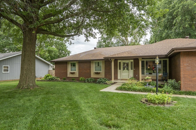 1820 E Jacqueline St, Springfield, MO 65804 - ranch-style house featuring brick siding, a front lawn, roof with shingles, and covered porch
