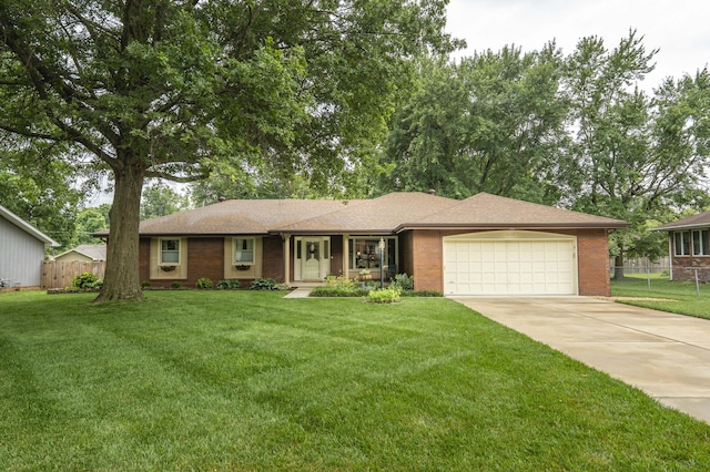 1820 E Jacqueline St, Springfield, MO 65804 - single story home featuring a garage, concrete driveway, and brick siding