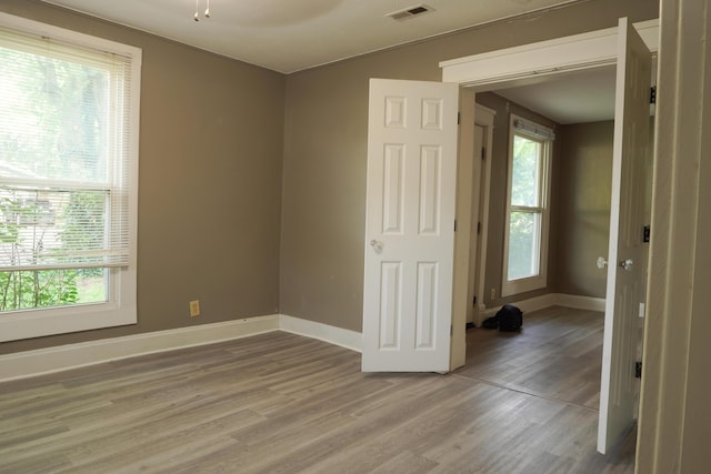 1019 N Clifton Ave, Springfield, MO 65802 - empty room with light wood finished floors and baseboards