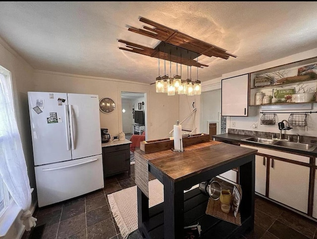 135 Coulter Ln, Forsyth, MO 65653 - kitchen with freestanding refrigerator, open shelves, dark countertops, decorative light fixtures, and dark stone finish flooring