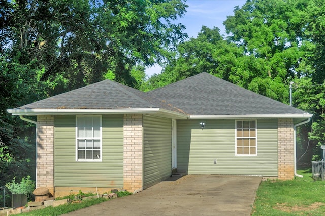 2431 N Kellett Ave, Springfield, MO 65803 - view of front of home featuring roof with shingles and brick siding
