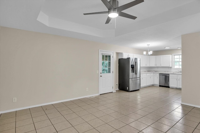 2431 N Kellett Ave, Springfield, MO 65803 - kitchen with appliances with stainless steel finishes, a chandelier, light countertops, light tile patterned flooring, and white cabinetry