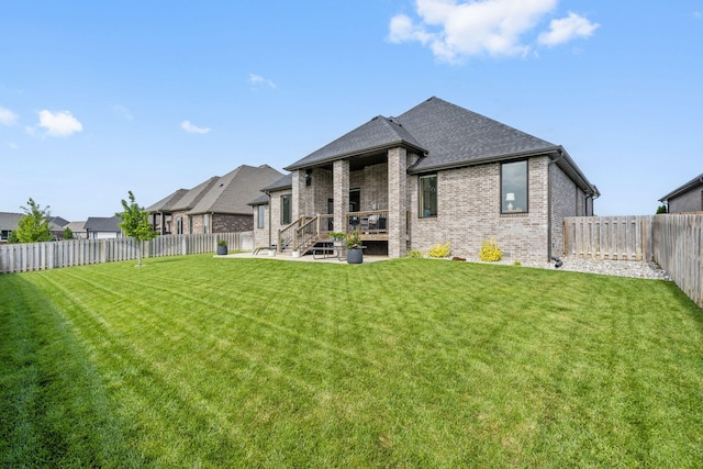 858 E Edenmore Cir, Nixa, MO 65714 - back of property featuring brick siding, a fenced backyard, a patio, and roof with shingles