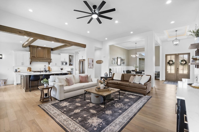 858 E Edenmore Cir, Nixa, MO 65714 - living room featuring a ceiling fan, light wood-style floors, recessed lighting, and a chandelier