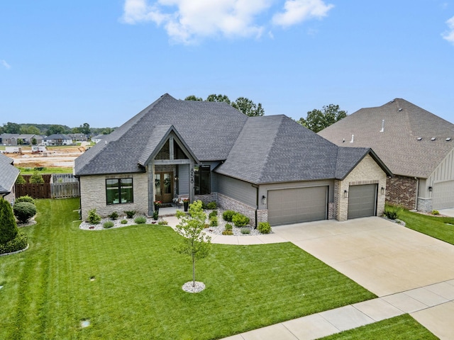 858 E Edenmore Cir, Nixa, MO 65714 - view of front of home featuring a garage, a shingled roof, concrete driveway, and stone siding
