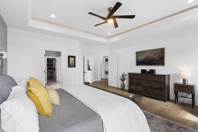 858 E Edenmore Cir, Nixa, MO 65714 - bedroom featuring a raised ceiling, wood finished floors, recessed lighting, ceiling fan, and a walk in closet