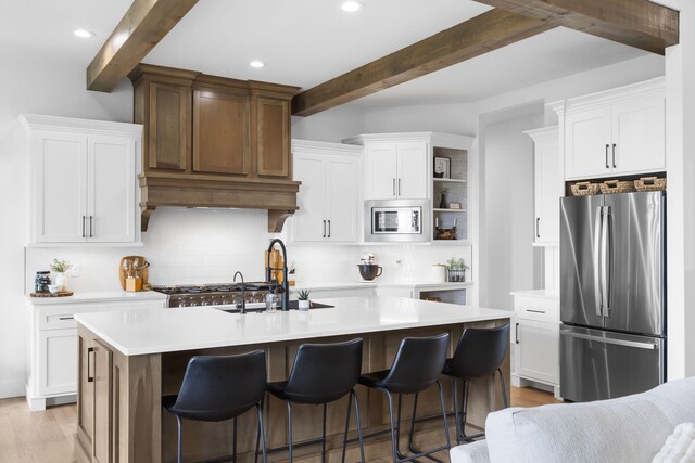 858 E Edenmore Cir, Nixa, MO 65714 - kitchen featuring stainless steel appliances, beam ceiling, tasteful backsplash, light countertops, and white cabinetry