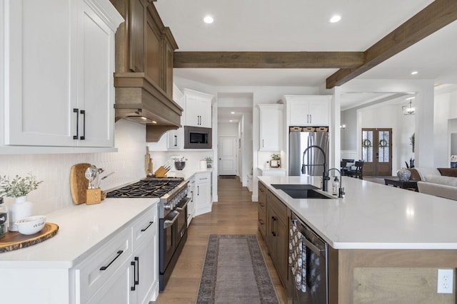 858 E Edenmore Cir, Nixa, MO 65714 - kitchen with stainless steel appliances, recessed lighting, beamed ceiling, wood finished floors, and decorative backsplash