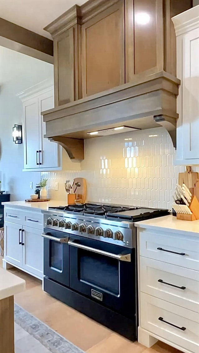 858 E Edenmore Cir, Nixa, MO 65714 - kitchen featuring range with two ovens, light countertops, tasteful backsplash, and white cabinetry