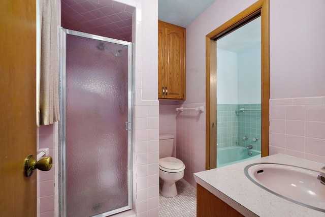 3066 E Lomita St, Springfield, MO 65804 - full bath featuring tile walls, a shower stall, vanity, tile patterned floors, and a wainscoted wall