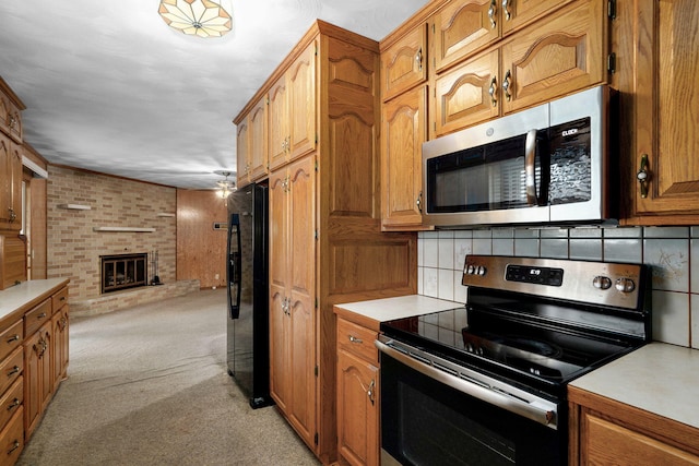 3066 E Lomita St, Springfield, MO 65804 - kitchen with appliances with stainless steel finishes, open floor plan, light countertops, tasteful backsplash, and light carpet