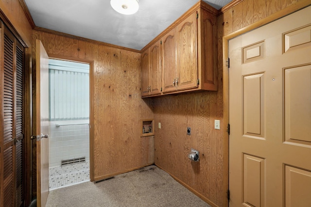 3066 E Lomita St, Springfield, MO 65804 - laundry area featuring cabinet space, light carpet, hookup for an electric dryer, hookup for a washing machine, and wood walls
