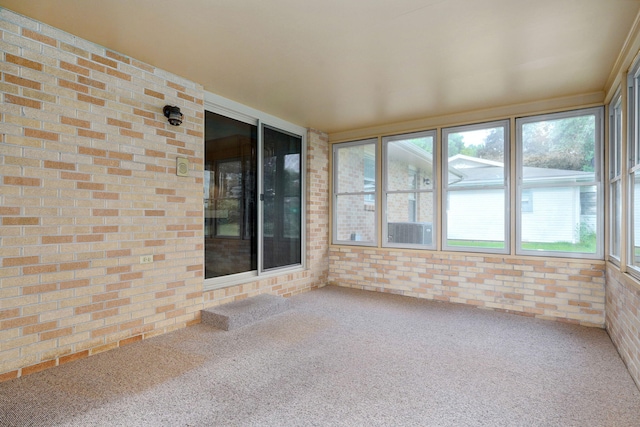 3066 E Lomita St, Springfield, MO 65804 - unfurnished sunroom with brick wall, carpet flooring, and plenty of natural light