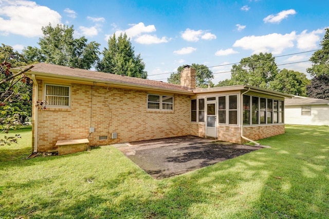 3066 E Lomita St, Springfield, MO 65804 - rear view of house featuring a chimney, a patio area, a sunroom, a yard, and brick siding