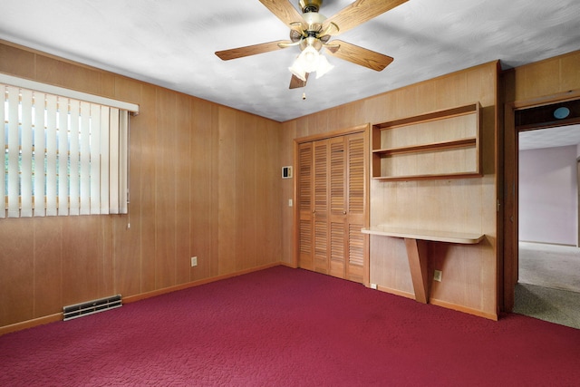 3066 E Lomita St, Springfield, MO 65804 - unfurnished bedroom with carpet floors, a closet, wooden walls, and ceiling fan