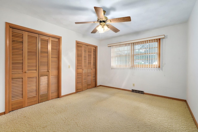 3066 E Lomita St, Springfield, MO 65804 - unfurnished bedroom featuring two closets, carpet floors, and a ceiling fan