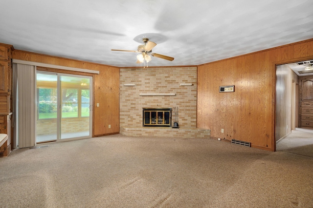 3066 E Lomita St, Springfield, MO 65804 - unfurnished living room with ceiling fan, wood walls, carpet flooring, and a fireplace
