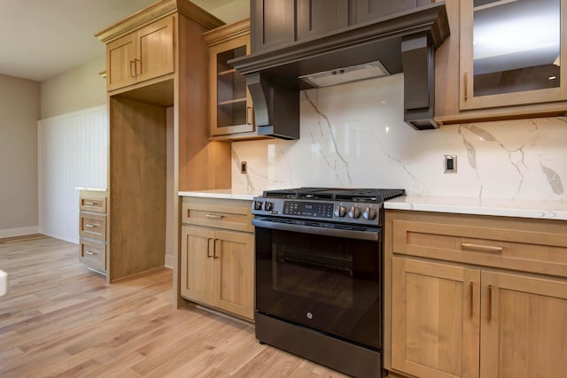 6059 S Clay Ave, Springfield, MO 65810 - kitchen with stainless steel gas range oven, backsplash, light wood-style flooring, and light countertops