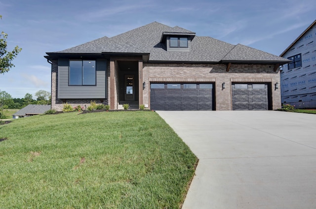 6059 S Clay Ave, Springfield, MO 65810 - view of front of house featuring brick siding, an attached garage, driveway, a front yard, and roof with shingles