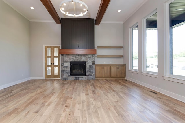 6059 S Clay Ave, Springfield, MO 65810 - unfurnished living room featuring beamed ceiling, light wood-style floors, ornamental molding, a stone fireplace, and a chandelier