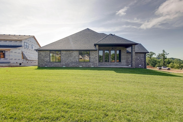 6059 S Clay Ave, Springfield, MO 65810 - back of property with a shingled roof, a yard, and brick siding