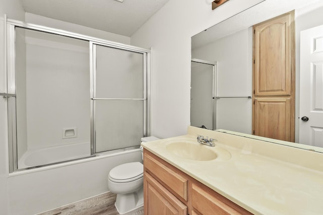 3440 S Delaware Ave Unit 114, Springfield, MO 65804 - full bathroom featuring vanity, wood finished floors, and bath / shower combo with glass door